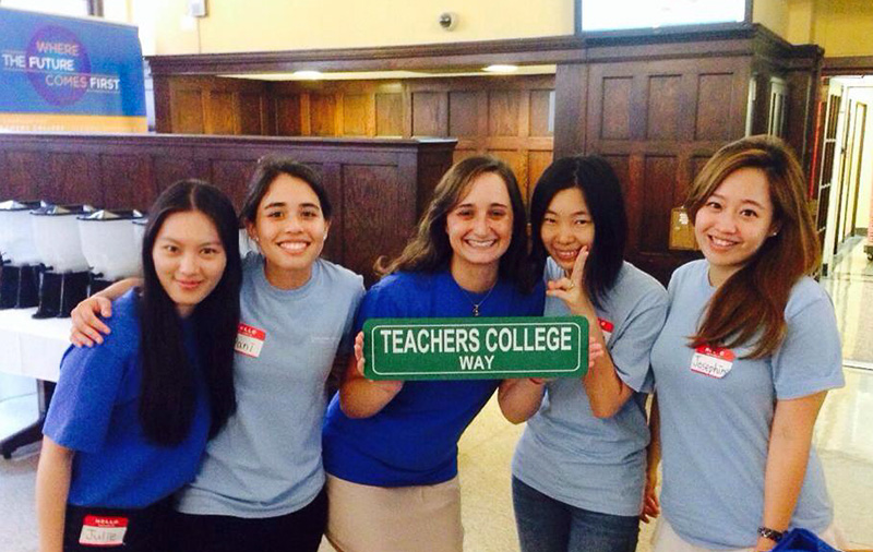 Pre TC Immersion students and mentor hold Teachers College Way sign